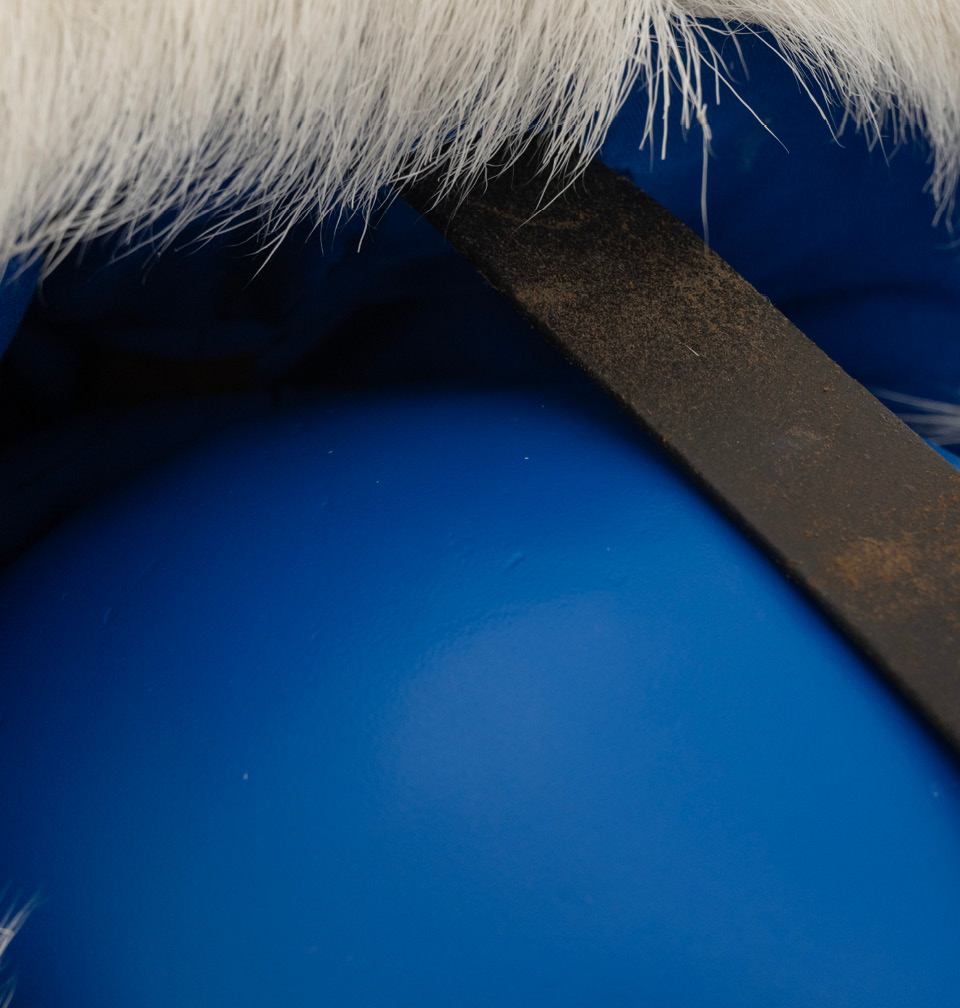 Detail of the hoofed shoes on the blue plinth